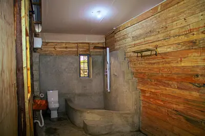 a bathroom with a bath tub and a toilet at Twende Home lodge in Arusha