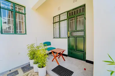 a room with a green door and plants at Maasai Villa in Arusha