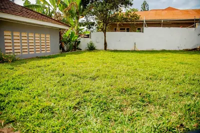 a yard of a house with a green lawn at The Nook at Njiro 39 - 3BR by Kyada Stays in Arusha