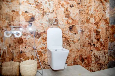 a bathroom with a white toilet in a room at The Nook at Njiro 39 - 3BR by Kyada Stays in Arusha