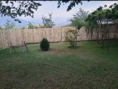 a backyard with a wooden fence and a bench at Pumzika hill homes in Arusha