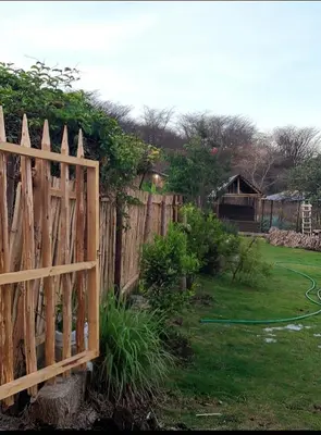a wooden fence in a backyard with a yard at Pumzika hill homes in Arusha