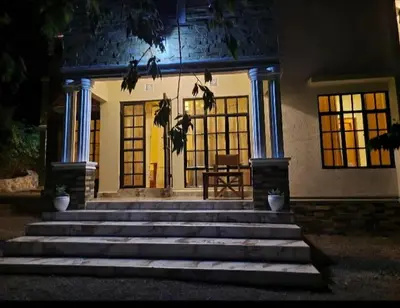 a front porch of a house at night at Pumzika hill homes in Arusha