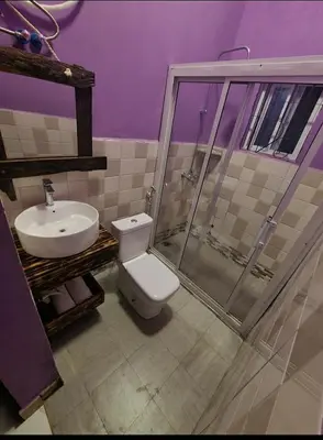 a bathroom with a toilet and a sink at Pumzika hill homes in Arusha