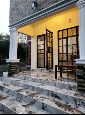 a front porch of a house with a bench at Pumzika hill homes in Arusha