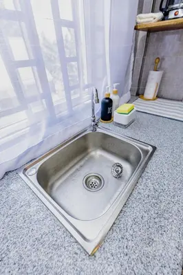 a stainless steel sink in a kitchen with a window at Serene and Amara By Tadre House's in Arusha