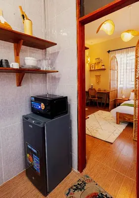 a kitchen with a stove on top of a refrigerator at Serene and Amara By Tadre House's in Arusha
