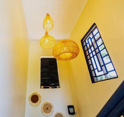 a room with three lights and a window at Serene and Amara By Tadre House's in Arusha