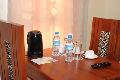 a wooden table with two bottles of water on it at Blue Junction Eco Lodge in Arusha