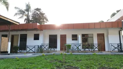 a large white building with a red roof at Blue Junction Eco Lodge in Arusha