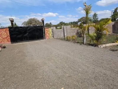 a driveway with a fence with a gate at Shavia Home in Arusha