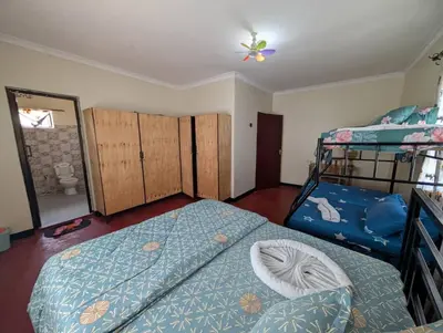 a bedroom with a bed and two bunk beds at Shavia Home in Arusha