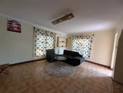 a living room with a couch and a table at Shavia Home in Arusha