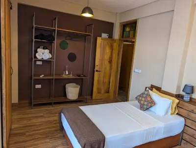 a bedroom with a bed and a book shelf at Explorers Kilimanjaro Boutique Hotel in Moshi