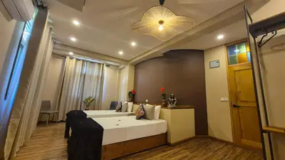 a hotel room with a bed and a light at Explorers Kilimanjaro Boutique Hotel in Moshi