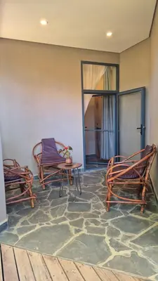 two chairs and a table in a room at Explorers Kilimanjaro Boutique Hotel in Moshi