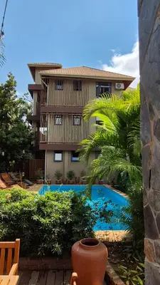 a view of a building and a swimming pool at Explorers Kilimanjaro Boutique Hotel in Moshi