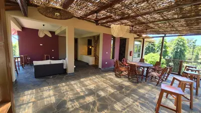 a patio with tables and chairs on a balcony at Explorers Kilimanjaro Boutique Hotel in Moshi