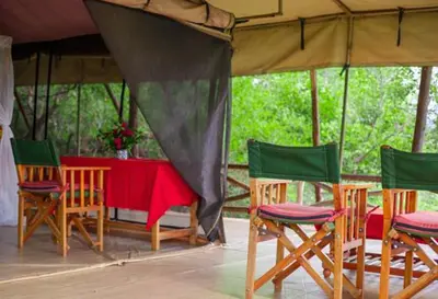 a table and chairs in a gazebo at Havennature Safari Camp and Lodge in Namalulu