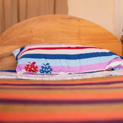 a pillow sitting on top of a bed at Havennature Safari Camp and Lodge in Namalulu