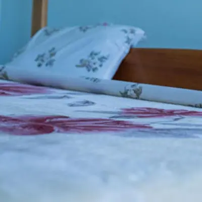 a bed with a pillow on top of it at Havennature Safari Camp and Lodge in Namalulu