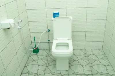 a bathroom with a white toilet in a stall at Rest and Stay Minutes from Kilimanjaro Airport in Arusha