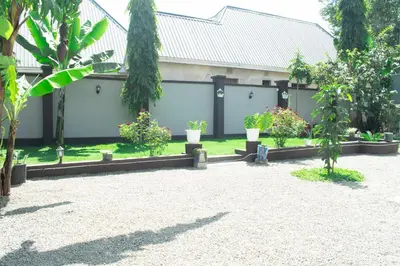 a building with potted plants in a courtyard at Rest and Stay Minutes from Kilimanjaro Airport in Arusha