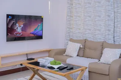 a living room with a couch and a coffee table at Sonia homes shared in Arusha