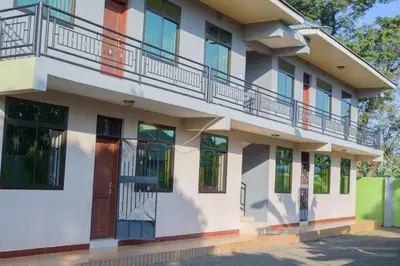 an apartment building with a balcony and a door at Sonia homes shared in Arusha