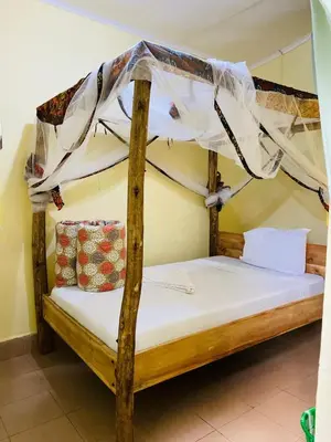 a bedroom with two bunk beds with a canopy at Kilimanjaroo Inn in Moshi