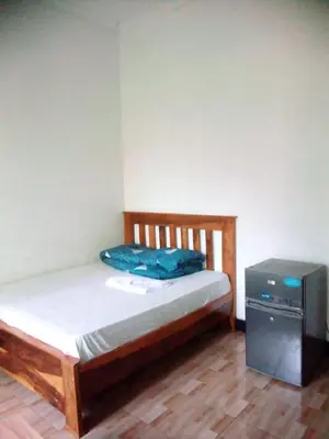 a small bedroom with a bed and a television at Banana Grove Retreat in Shiri