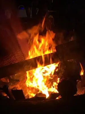 a fire burns in a fire pit at night at Bomani House in Arusha