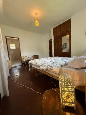 a bedroom with a large bed in a room at Bomani House in Arusha