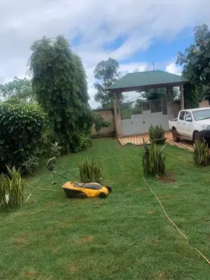 a yellow kayak laying on the grass in a yard at Aa peaceful resting home in Karatu