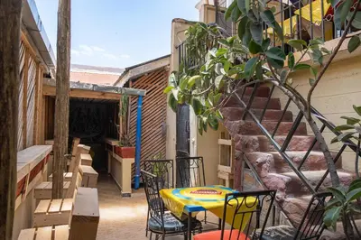 a patio with a table and chairs and a staircase at Seuri Bar and Guesthouse in Arusha