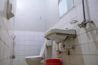 a bathroom with a sink and a toilet at Seuri Bar and Guesthouse in Arusha
