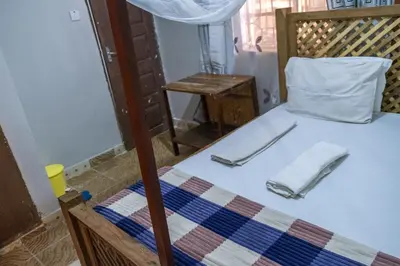 a bed with two utensils sitting on top of it at Seuri Bar and Guesthouse in Arusha