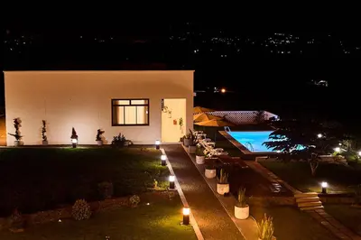 a house with a swimming pool at night at Smile Apartments Arusha in Arusha