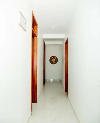 a hallway with two doors and a painting on the wall at Smile Apartments Arusha in Arusha
