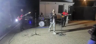 a group of people on a stage playing music at Smile Apartments Arusha in Arusha