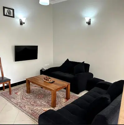 a living room with a couch and a coffee table at MD Apartments in Arusha