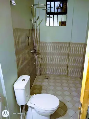 a bathroom with a toilet and a shower at Anapa Lodge and Camp in Mto wa Mbu
