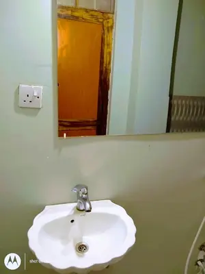a white sink in a bathroom with a mirror at Anapa Lodge and Camp in Mto wa Mbu