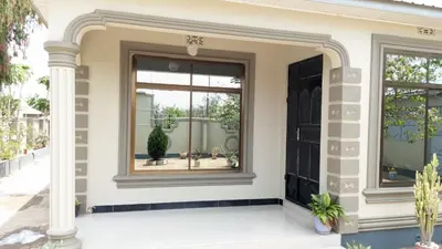 a front door of a house with a window at Mama Evaline Family Home in Boma la Ngombe