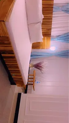 a room with a staircase and a person in the water at Mama Evaline Family Home in Boma la Ngombe