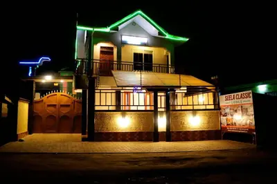a building with green lights on it at night at SEELA CLASSIC LODGE-Mbauda Arusha Tanzania in Arusha