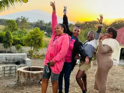 a group of people with their arms in the air at Mlangoni Cottages in Sanya Juu