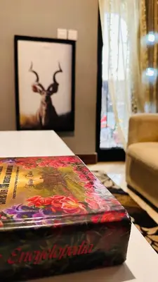 a book sitting on a table with a picture of a deer at Sanplay Homes in Arusha
