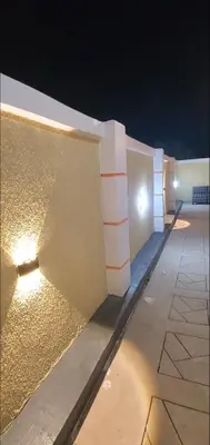 a wall with lights on the side of a building at Ma lo Lounge n Lodge
