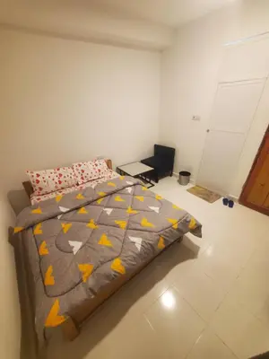 a bedroom with a bed with a comforter at Ma lo Lounge n Lodge